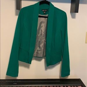 Green blazer with black and white stripes inside